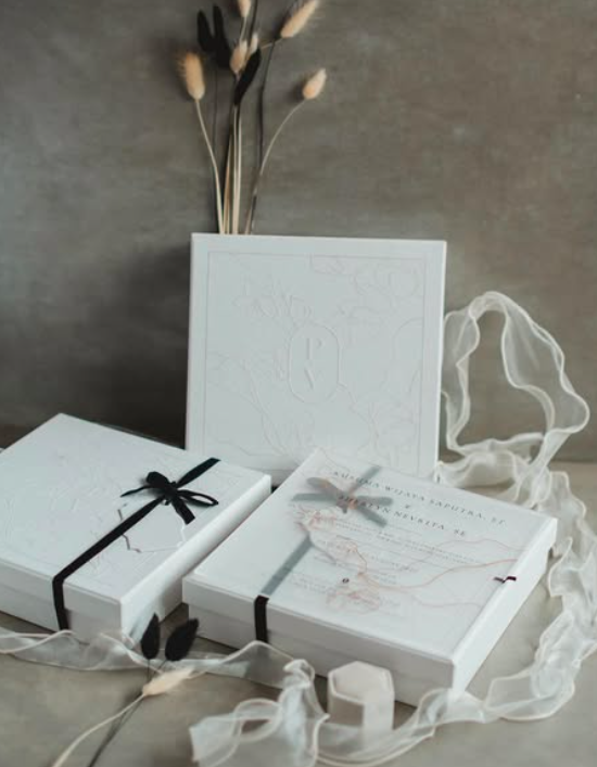 Warm flatlay of artisan local treats, natural soap, and a branded box with ribbon
