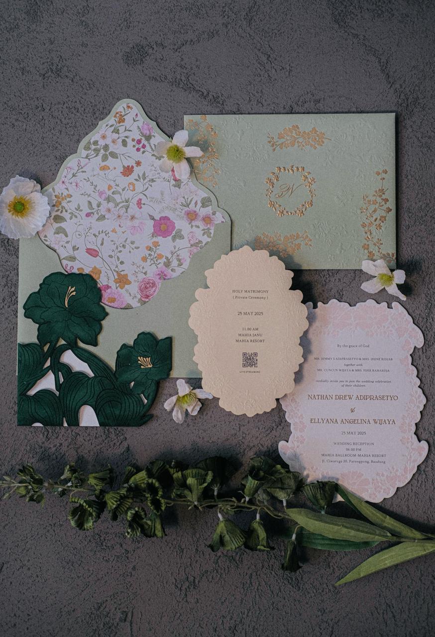Botanical wedding invitation suite with lush green florals and gold foil